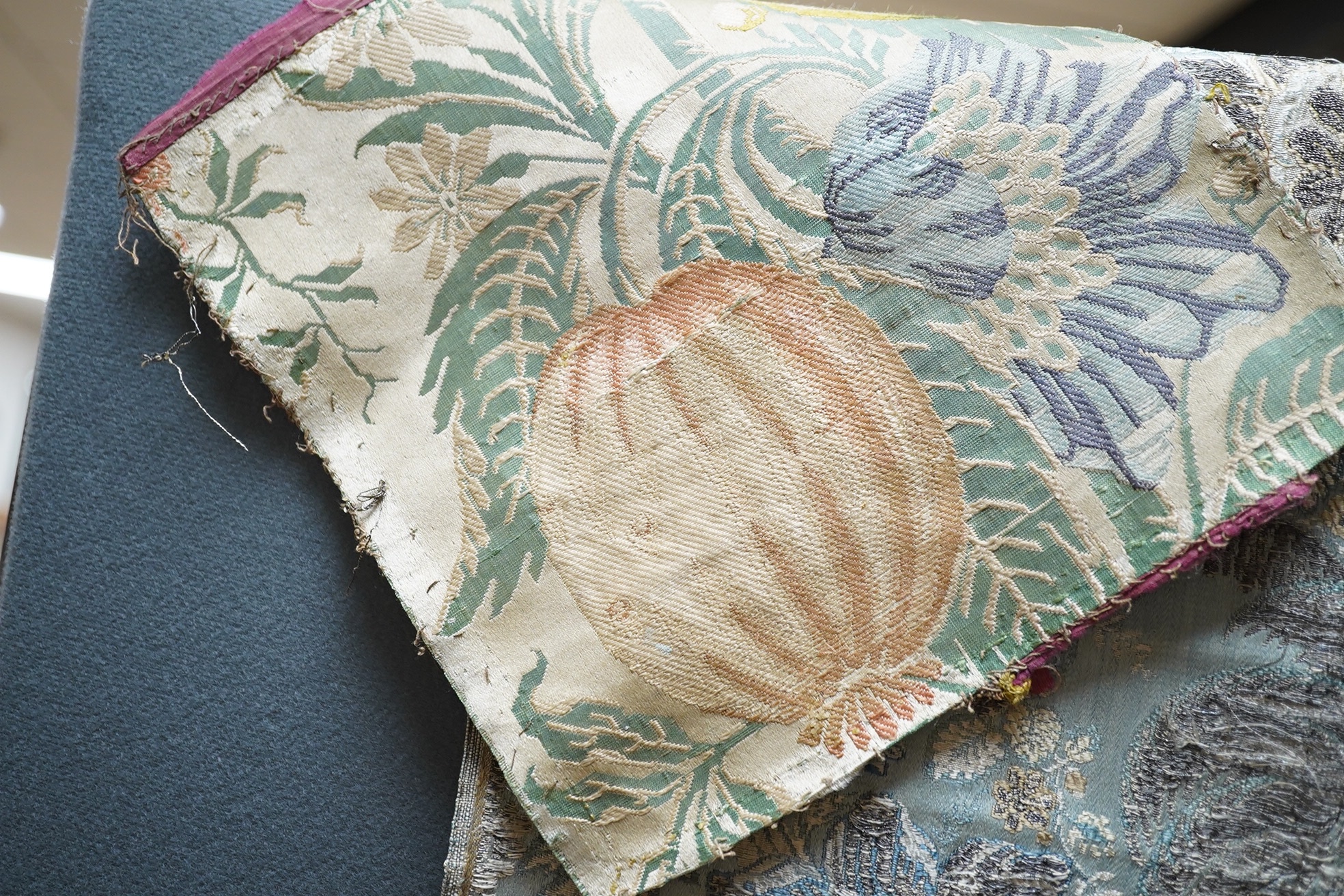 Samples of 18th century French, possibly Lyon silk, short loom brocades including two pairs and three single samples of varying sizes, one pair multi polychrome of large exotic flowers and fruits, the other pair pale blu